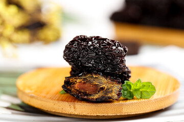 Xinjiang Dried Jujube Dates on Wooden Plate with Mint - Traditional Chinese Fruit Delicacy