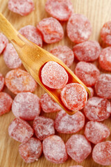 Sweet Sugar Coated Dried Kumquat Preserves on Wooden Spoon - Candied Citrus Fruit Snack