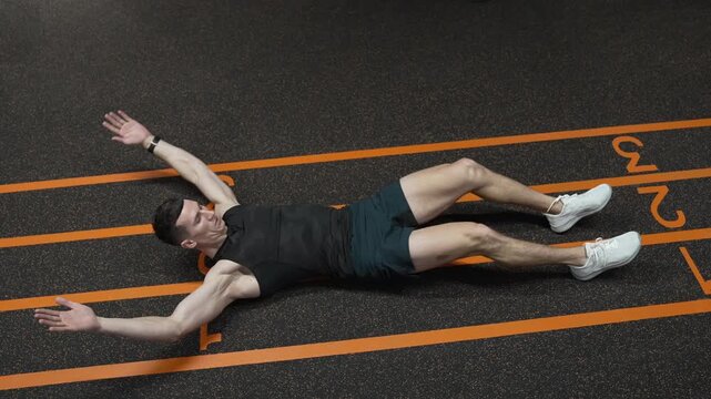 Leg crunches man in training. Sporty man training abs. Sixpack leg crunches exercise. Muscular sportsman do abs workout. Abdominal exercise. Exercise for abs sixpack torso muscle