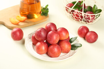 Fresh Red Plums on White Plate with Honey Jar - Healthy Organic Fruit Display