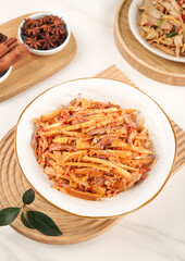 Spicy Shredded Bamboo Shoots Stir-Fry Display with Traditional Asian Spices on Wooden Board