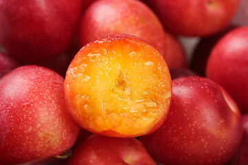 Fresh Australian Red Plums Cut in Half Showing Golden Juicy Flesh