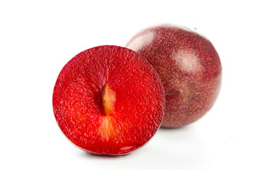 Fresh Red Plum Cut in Half Showing Crimson Flesh Isolated on White Background