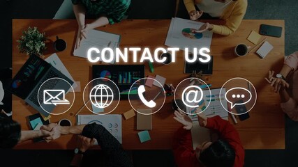 A dynamic collaborative team meeting featuring diverse individuals engaging in discussions at a workspace with contact icons for effective communication and connectivity. Raster - Powered by Adobe