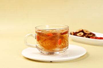 Corn silk tea brewing in glass cup - healthy herbal drink with cornhusk strands and natural ingredients