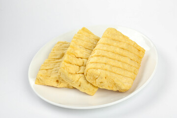 Dried Tofu Slices on White Plate - Traditional Chinese Soy Protein Food Ingredient
