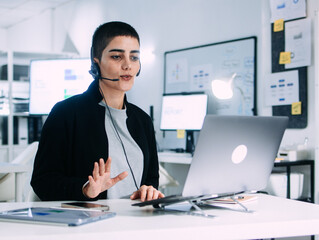 Focused Female Customer Service Support Agent working on computer Talking to Client Online in Virtual meeting, Telemarketing Sales at Call Center Office. Female Technical support Operator working.
