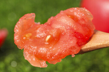 Fresh Ripe Tomato Slice with Seeds on Wooden Spoon - Natural Organic Vegetable Close-up