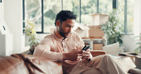 Moving, boxes and man with smartphone, new home or browsing renovation ideas on social media or web. Scroll, online and person with tech for remodeling, relax or research for interior design in house