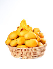 Fresh Tainong Mangoes in Wicker Basket with Dried Mango Slices on White Background