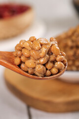 Japanese Natto Fermented Soybeans on Wooden Spoon - Traditional Healthy Probiotic Food