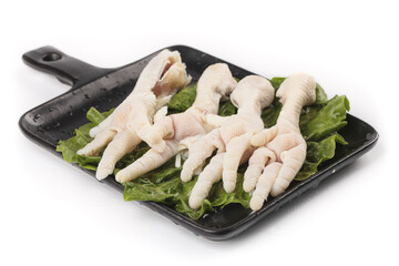 Fresh Raw Chicken Feet with Claws on Black Cutting Board for Asian Cooking