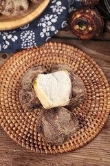 Fresh Taro Roots in Wicker Basket - Traditional Asian Cooking Ingredient on Rustic Wooden Table