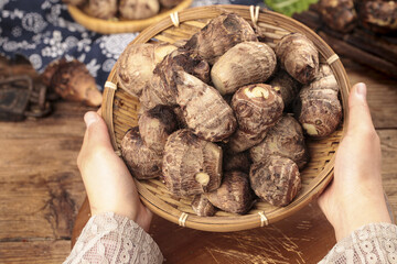 Fresh Taro Roots in Bamboo Basket - Traditional Asian Vegetable Display