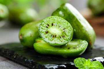 Fresh Mini Kiwi Berry Slices with Heart Pattern Seeds on Slate Board