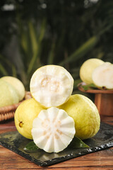 Fresh Guava Fruit Cut in Half Showing Soft Cream Flesh and Heart-Shaped Seeds on Rustic Wood Surface
