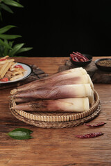 Fresh Peeled Bamboo Shoots in Wicker Basket on Wooden Table with Asian Cooking Ingredients