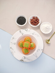Traditional Asian Persimmon Dessert with Sesame Seeds and Peanuts on Marble Plate