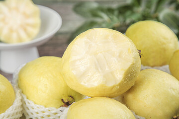 Fresh Yellow Guavas with Cream Heart-Shaped Flesh in White Basket - Tropical Fruit Photography