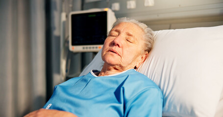 Fototapeta premium Sleeping, woman and senior patient in hospital for recovery of surgery, diagnosis or treatment. Sick, rest and elderly female person in bed for medical consultation or appointment in ward at clinic.