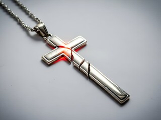 Fototapeta premium Detailed Close-Up of a Silver Cross Pendant with Intricate Design and Subtle Lighting