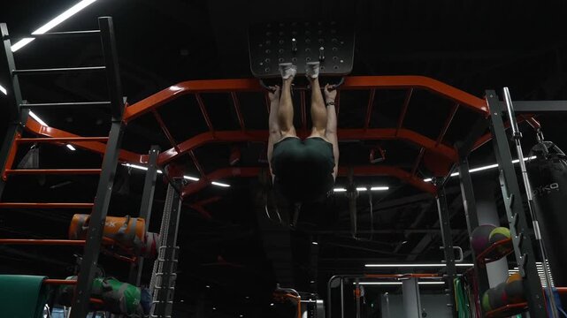 Sporty man training abs. Power exercise by hanging leg raises. Muscular sportsman do abs workout. Lifting legs. Exercise for abs sixpack torso muscle. Hanging leg raises or man in training