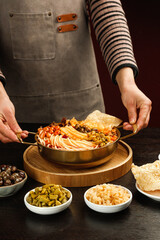 Chef Preparing Chinese Hotpot with Bamboo Shoots and Vermicelli Noodles on Wooden Board