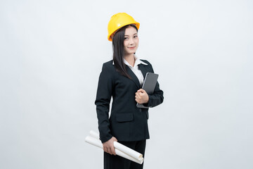 An Asian female engineer, standing confidently in a white background studio, holds a blueprint and places her laptop nearby as a symbol of her contributions to technology and industry.