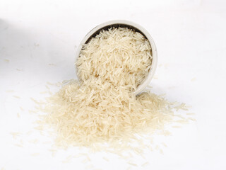 Long Grain Fragrant Basmati Rice Spilling from Bowl on White Background - Agricultural Food Products