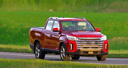 Modern pickup crossing rural farmland at speed © AlexGo