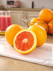 Fresh Blood Oranges with Red Flesh on Kitchen Counter - Healthy Citrus Fruit Display