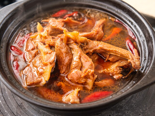 Spicy Marinated Duck Collarbone in Red Chili Broth - Traditional Asian Clay Pot Cooking