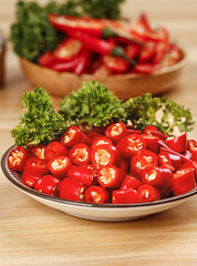 Fresh Red Chili Peppers Sliced on White Plate with Parsley Garnish