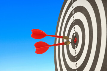 Red darts hit a target board with clarity and sharp precision