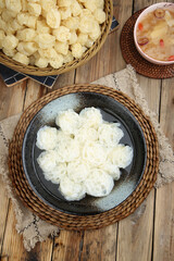 Fresh rice noodles with soup and puffed crackers traditional Asian meal wooden table setting