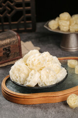 Traditional Chinese bird's nest soup in ceramic bowl on wooden serving tray, premium Asian health food delicacy