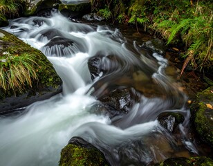 Serene stream flows over mossy rocks (1)