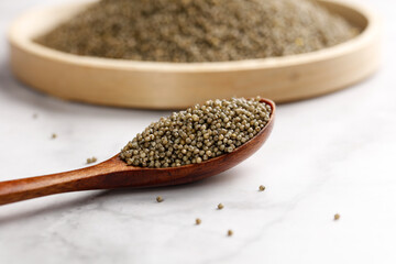 Organic Millet Grains in Wooden Spoon - Healthy Ancient Cereal Superfood for Gluten-Free Cooking