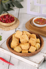 Golden Fried Tofu Puffs in Wooden Bowl with Sauce and Beans Vegetarian Cooking