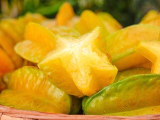 Fresh Star Fruit Carambola Slices in Basket - Tropical Golden Yellow Fruit with Five-Pointed Star Cross Section