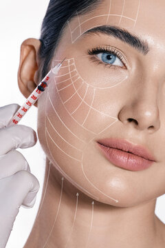 Fototapeta Beauty injections, lifting lines on a woman's face, advertising of skin tightening. Injections in eye area, nasolabial folds, forehead