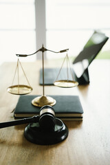 A judge's gavel placed on a wooden desk beside a laptop, symbolizing law, justice, court decisions, and legal proceedings in a modern office.