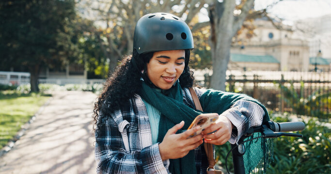 Notification, communication and woman in park with phone, digital and social media on internet. Happiness, online and African person on bicycle with smile, scrolling and reading for entertainment