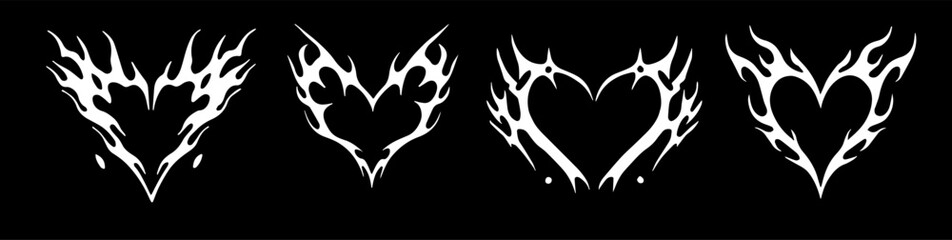 Vector illustration features four stylized white tribal flame heart designs on a black background. The edgy tattoo-inspired style combines love and fire motifs using bold, dynamic shapes and contrast.