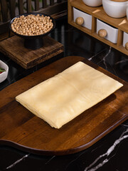 Handmade Tofu Skin Sheets with Fresh Soybeans in Traditional Kitchen Setting