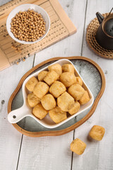 Traditional Golden Fried Tofu Cubes with Soybeans in Asian Casserole Dish