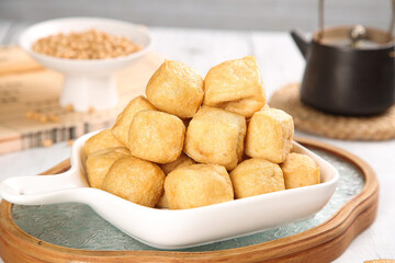 Golden Fried Tofu Puffs in White Bowl - Traditional Asian Vegetarian Food on Wooden Serving Tray