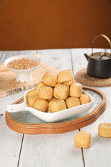 Fried Tofu Cubes in White Dish with Soybeans and Teapot - Asian Vegetarian Food Photography