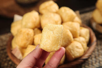 Golden Fried Tofu Puffs Handmade Crispy Vegetarian Snack Food in Wooden Bowl