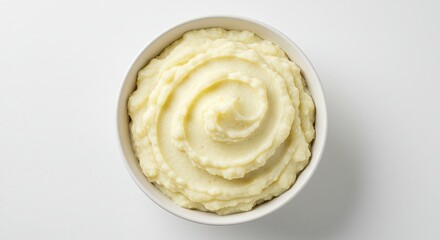 Creamy Mashed Potatoes Swirled in a White Bowl Overhead View.